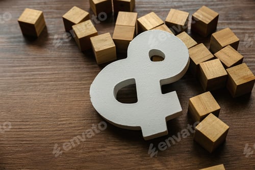 Preview: Wooden symbol ampersand on a brown wooden background.