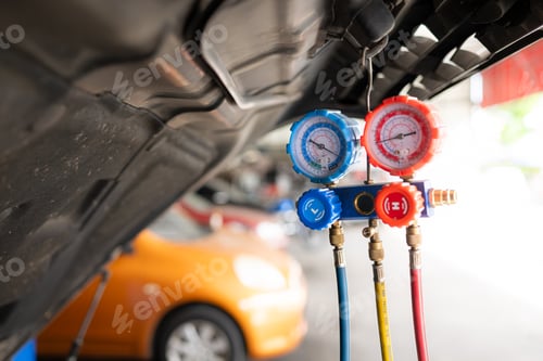 Preview: Car mechanic working in auto repair shop, inspecting the operation of the car's air conditioner