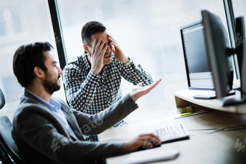Preview: Business colleagues working on computer and having problems
