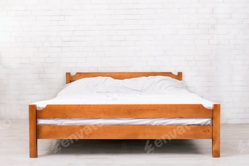 Preview: Wooden framed double bed with two pillows and blanket