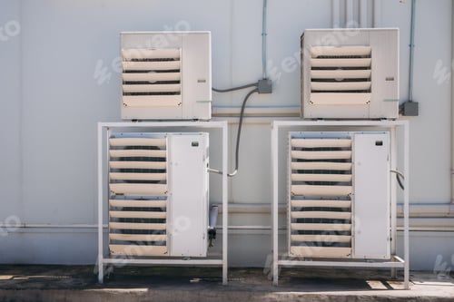 Preview: Air conditioner compressor installed on the wall of a building.