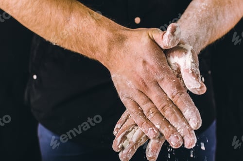 Preview: adult man hands work with flour, dark photo