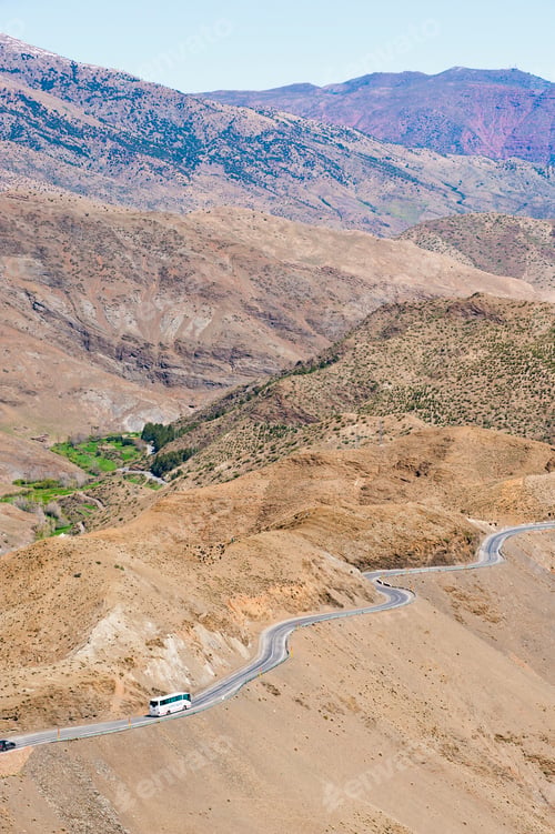 Preview: Tourist bus driving in the High Atlas Mountains just outside Marrakech on the Tizi n Tichka pass, Mo