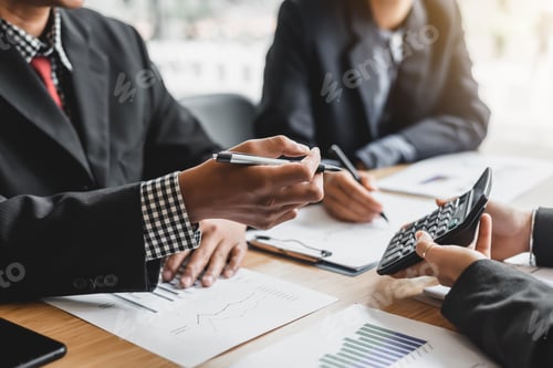 Preview: Business woman holding calculator to show their income and business profits at meeting.
