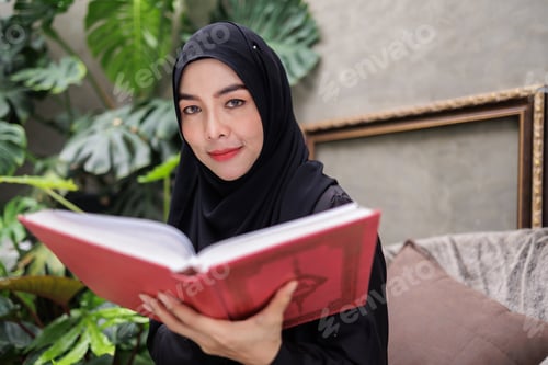 Preview: Engrossed in Literature, Woman in Hijab Reading with Interest