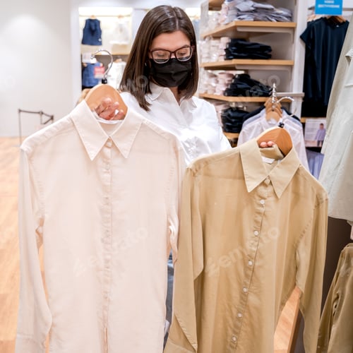 Preview: Woman Shopping for Shirts at Clothing Store