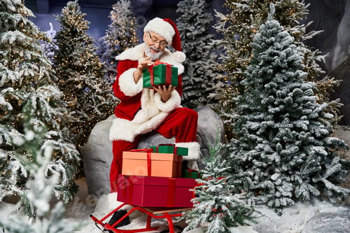 Preview: Santa Claus joyfully prepares gifts in a winter wonderland during the festive holiday season