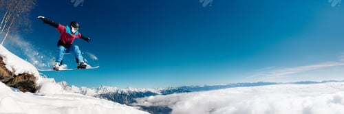 Preview: Snowboarder Jumping Over Mountains Wide Banner