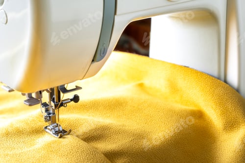 Preview: Modern sewing machine and yellow fabric. Sewing process, handmade, hobby, DIY, business, repair