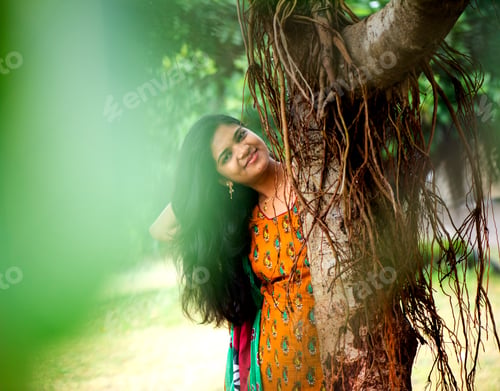 Preview: Happy woman near banyan tree