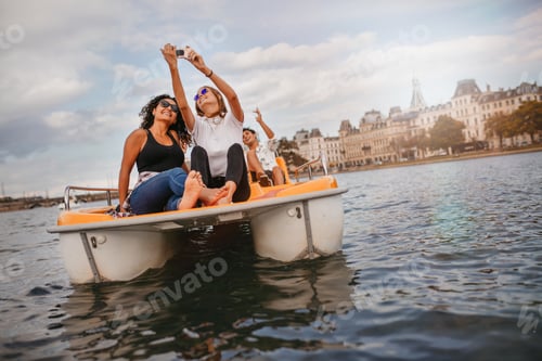 Preview: Young friends taking selfie on pedal boat