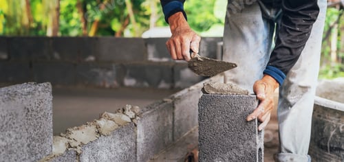 Preview: Construction Worker Builds Wall with Cinder Blocks