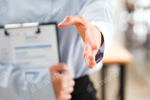 Preview: Businessperson's hand outstretched for a handshake, signaling readiness to engage.