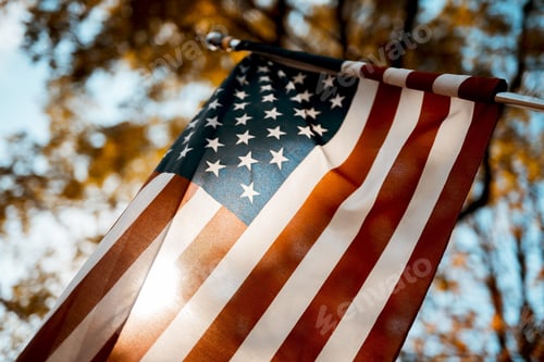 Preview: Flag of the united states shot from a low angle with a blurred background