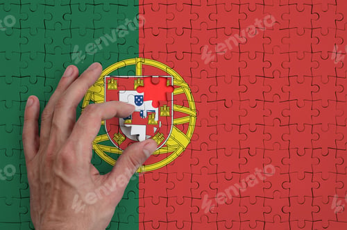 Preview: Portugal flag is depicted on a puzzle, which the man's hand completes to fold.