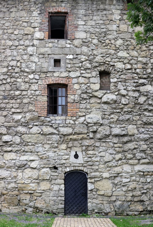 Preview: Ancient fortress stone wall with small door and windows