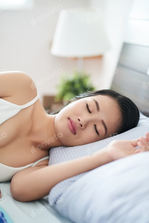 Preview: Sleeping Asian woman on bed