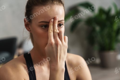 Preview: Attractive young woman practicing yogic breathing technique
