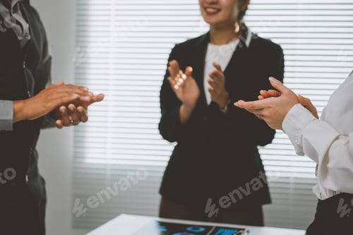 Preview: Business team clapping hands after successful presentation in office meeting room, celebrating corpo