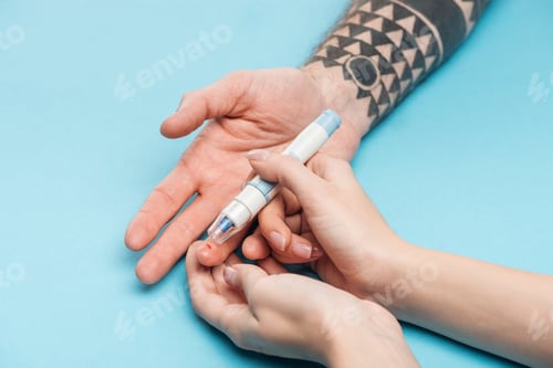 Preview: cropped view of woman testing man blood sugar level with syringe on blue background
