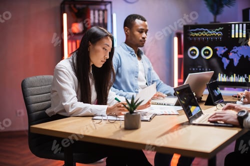 Preview: Diverse people analysing statistic of trade market at office