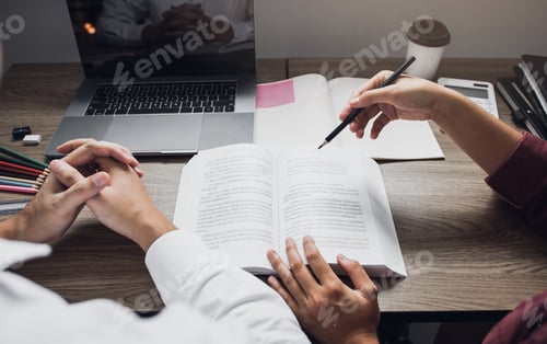 Preview: Teenage student works on homework in his room and writing in notebook.