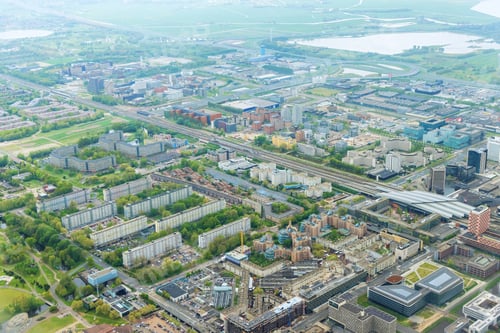 Preview: An aerial view of city Amsterdam, Netherlands, showing over rooftops of a neighborhood cloudy
