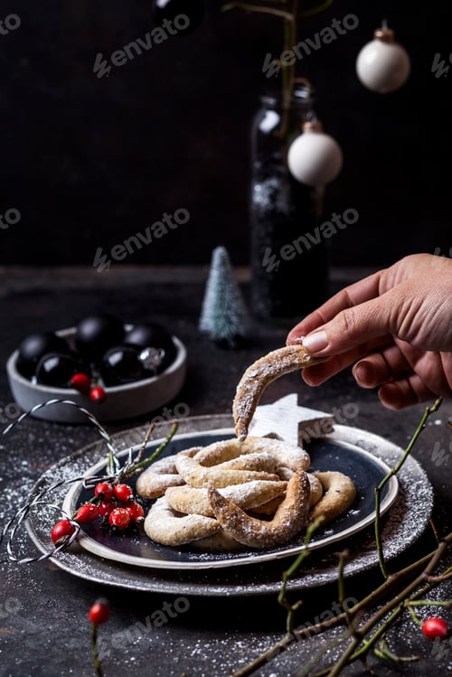 Preview: Woman's hand taking almond cookie