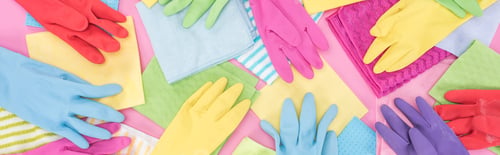 Preview: panoramic shot of scattered multicolored rags and rubber gloves on pink background
