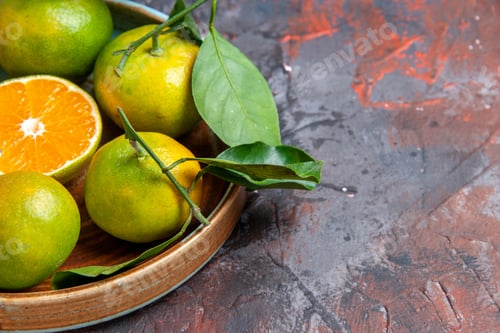 Preview: bottom half view fresh mandarines in bowl on dark red background with free space