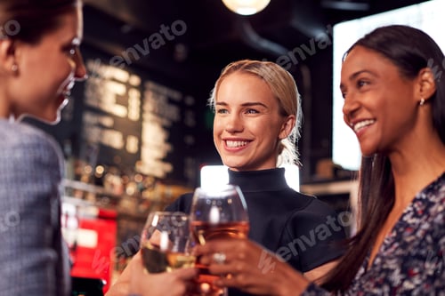 Preview: Three Women Making A Toast As They Meet For Drinks And Socialize In Bar After Work