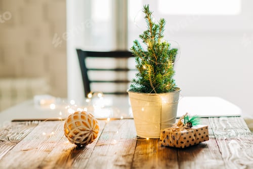 Preview: Still life fir tree Christmas winter holiday decorated with garland lights. Xmas home decorations