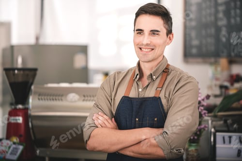 Preview: Male barista working at a coffee shop ready to order