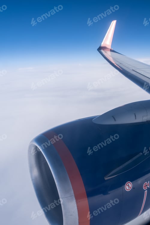 Preview: Airplane flight. Wing of an airplane flying above the clouds.