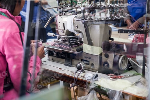 Preview: Seamstress working on industrial smocking sewing machine in factory, Cape Town, South Africa