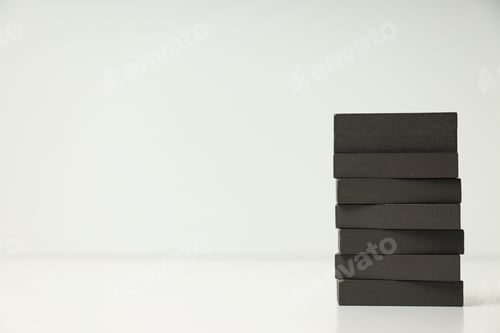 Preview: Tower of black wooden blocks on white background, place for text. World autism day concept