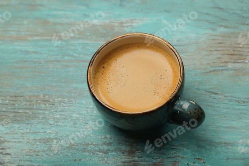 Preview: Espresso coffee in rustic blue cup on wooden table