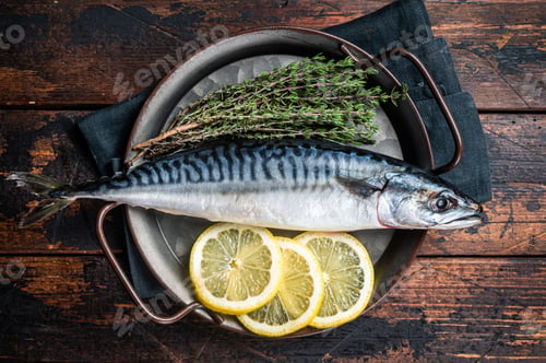Preview: Uncooked mackerel fish, raw scomber with herbs. Wooden background. Top view