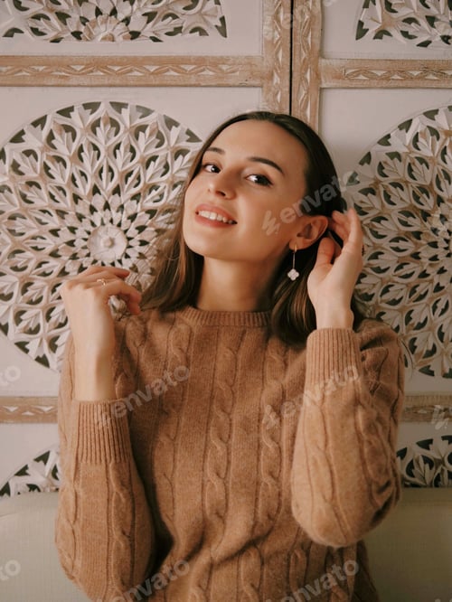 Preview: Smiling Woman in Brown Sweater Poses Indoors