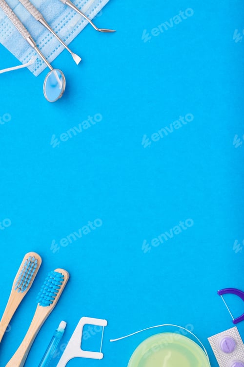 Preview: Dentist tools over blue background top view