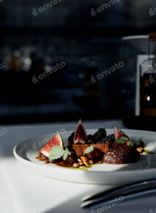 Preview: Vertical shot of a white plate with a figs dish