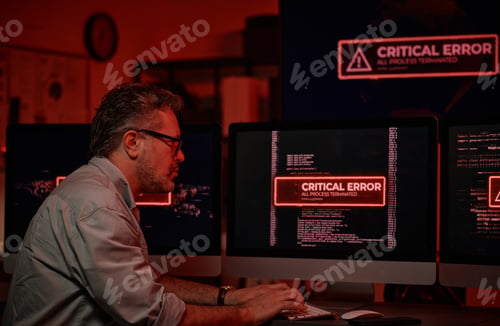 Preview: Side view of serious mature IT support manager trying to solve technical problem