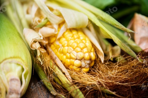 Preview: Aerial view of sweencorn cob on wooden background