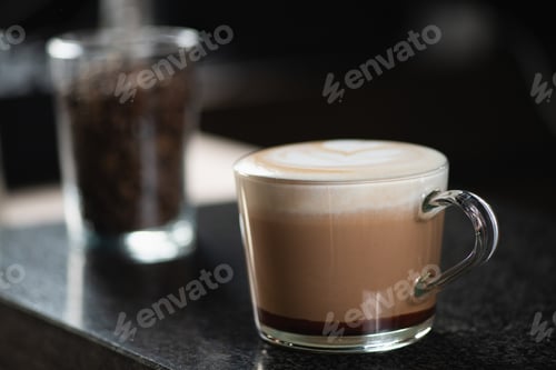 Preview: Barista's Hand Holds Mocha Coffee in a Glass Cup
