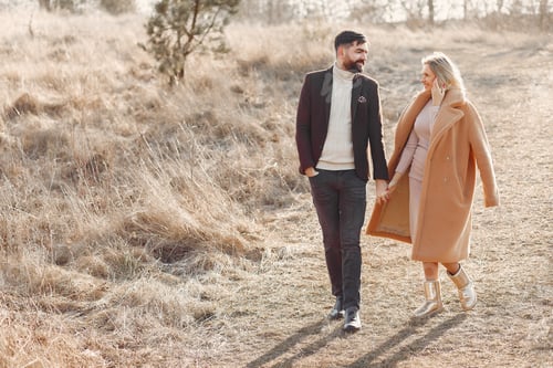 Preview: Couple walking in a spring field