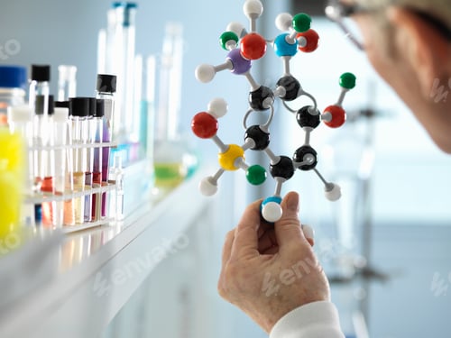 Preview: Scientist holding molecular model in laboratory
