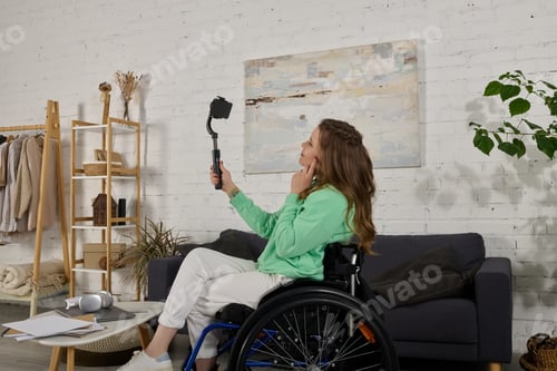 Preview: Young woman in wheelchair films at home