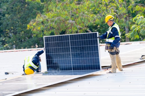 Preview: workers installing solar panels, for efficient energy on rooftop