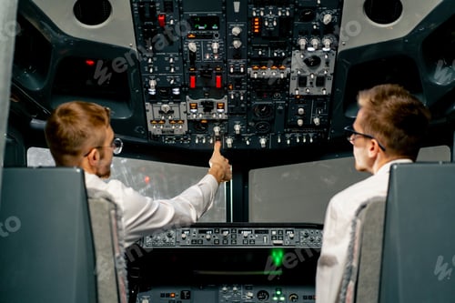 Preview: pilots in the cockpit of an airplane during flight control in turbulence zone flight simulator