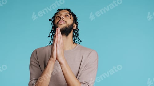 Preview: Pious man praying to his god, asking for forgiveness, feeling desperate, studio